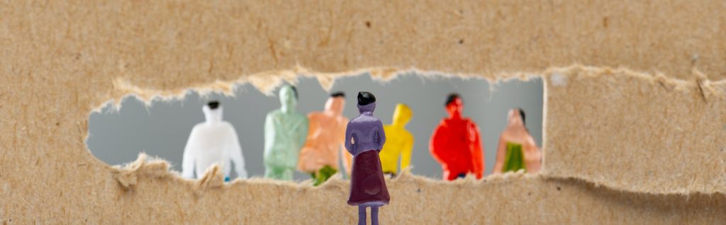 Concept of social rights with people figures near hole in cardboard isolated on grey, panoramic shot