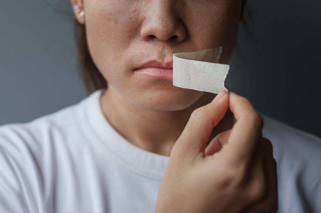 mouth sealed in adhesive tape. Free of speech, freedom of press, Human rights